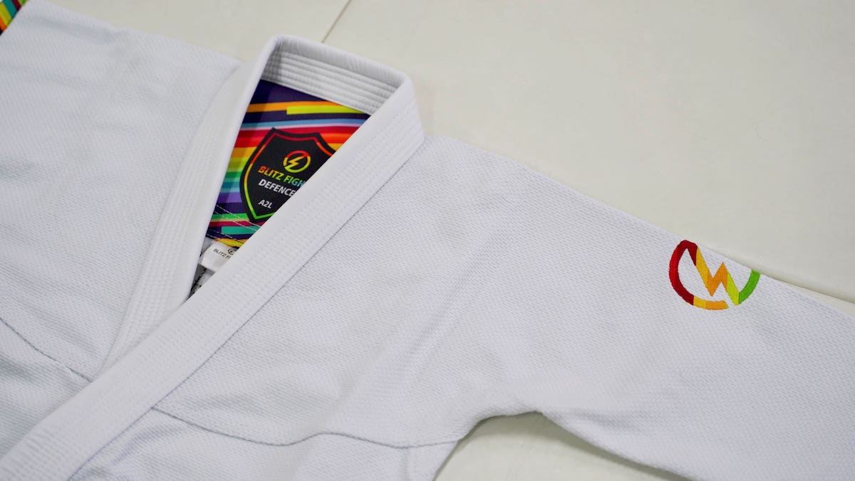 White custom BJJ gi showing collar label, inner lining detail and shoulder embroidery before production
