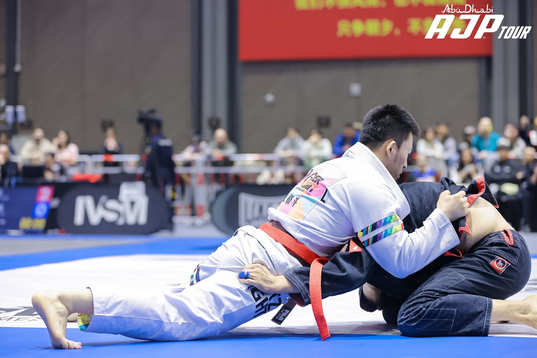 Competitors showcasing skills in a BJJ competition, demonstrating IBJJF Gi requirements.