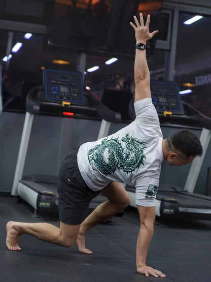 Athlete stretching at the gym wearing Dragon Year Limited Edition Rash Guard for Brazilian Jiu-Jitsu training.