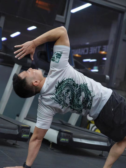 Man stretching in gym wearing Dragon Year Limited Edition Rash Guard for Brazilian Jiu-Jitsu.