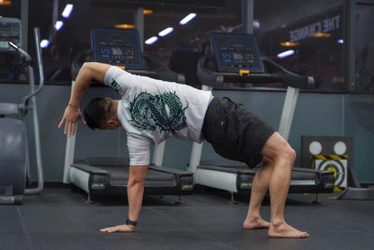 Athlete wearing Dragon Year Limited Edition Rash Guard performing a warm-up stretch at the gym.