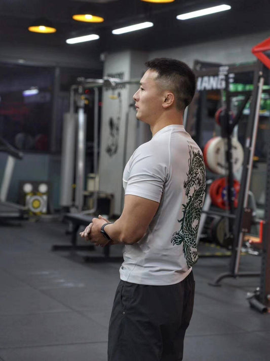 Man wearing Dragon Year Limited Edition Rash Guard in gym, showcasing high-performance BJJ gear for Brazilian Jiu-Jitsu training