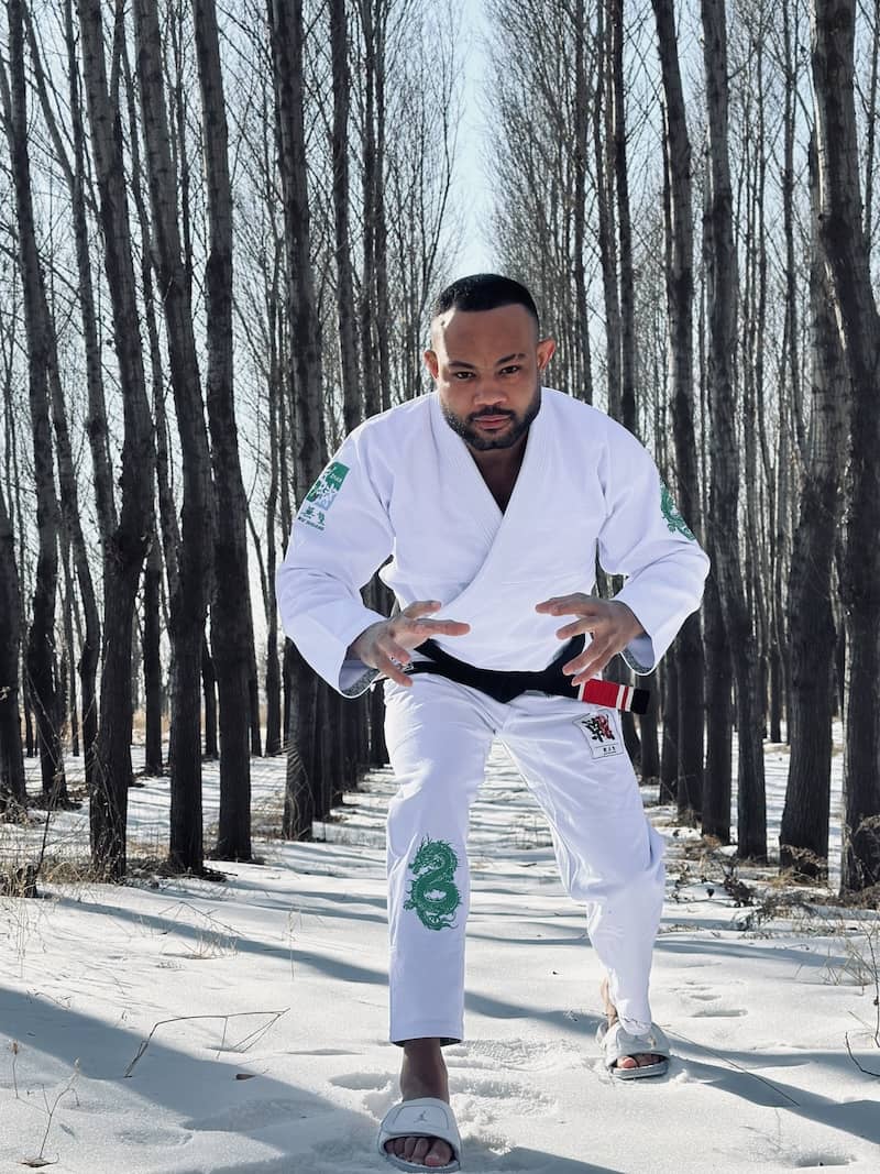 BJJ practitioner wearing the ZHAN Year of the Dragon Limited Edition Gi, ready to train in a snowy forest.