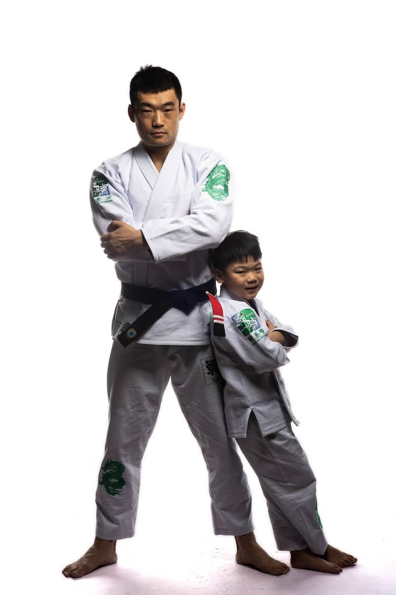 Adult and child wearing ZHAN Year of the Dragon Limited Edition BJJ Gi posed in stance