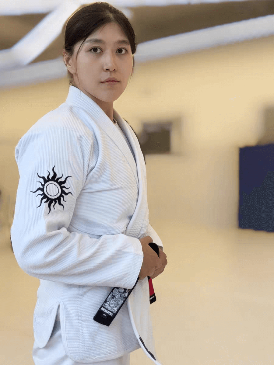 Unisex model wearing BLITZ Sun & Moon Series Brazilian Jiu-Jitsu Gi in training setting, showcasing durability and stylish design.