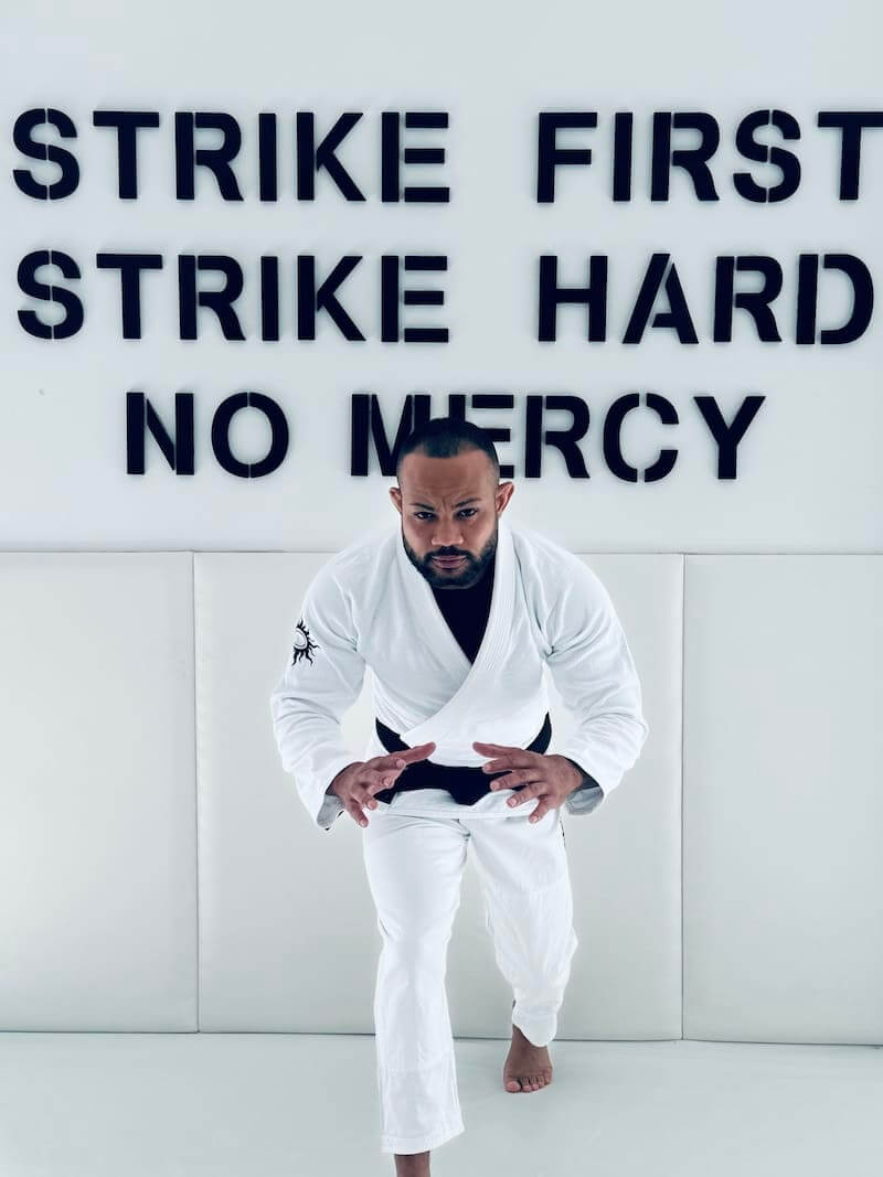 BLITZ Sun & Moon Brazilian Jiu-Jitsu Gi worn by a martial artist training in a modern dojo setting.