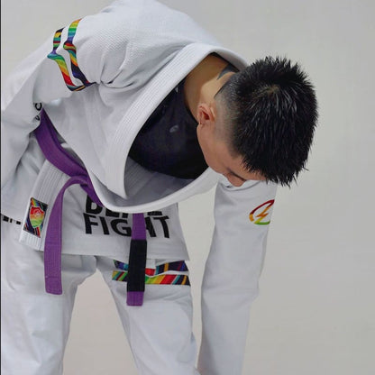 Model bending over in a white rainbow pattern BJJ gi