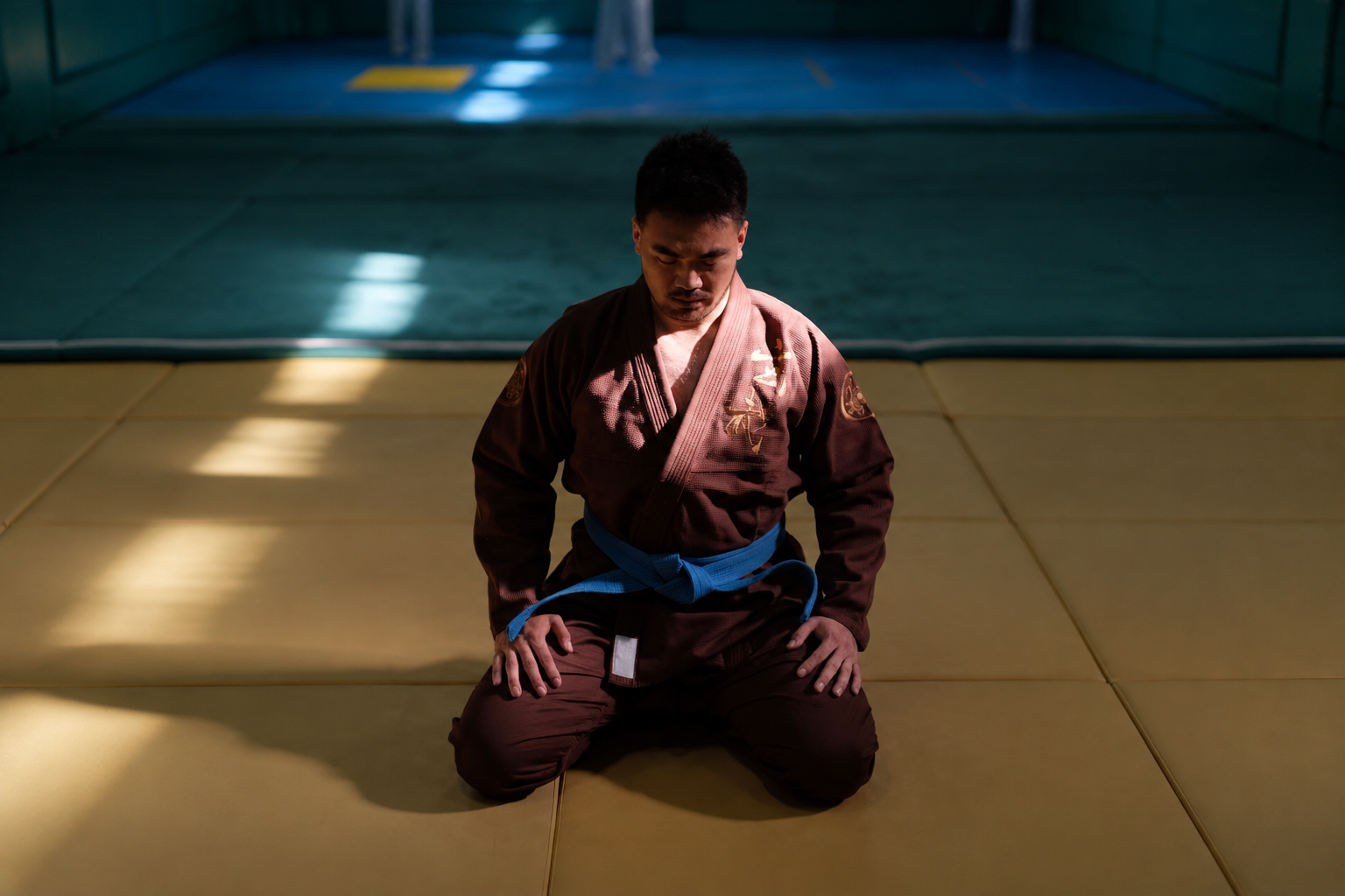 BJJ athlete wearing the ZHAN Xuanwu brown gi and blue belt on the training mat